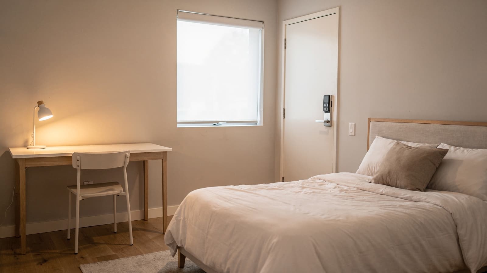 Private bedroom with a made bed, desk and window light in a shared Richmond home